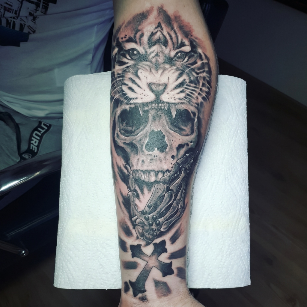 Realism tattoo — Tiger skull with cross